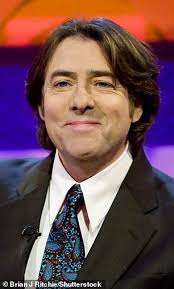 Jonathan Ross, 63, cuts a trendy ensemble in burgundy leather jacket and  sports VERY dark hair