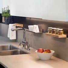 The designers created extra storage below the sink for tools and other essentials by hanging pleated curtains from rods. Kitchen Accessories 3s Design