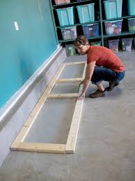 Learn how to build simple, cheap garage storage shelves that use the wasted space above your garage door! How To Build Oversized Garage Storage Cabinets Hgtv