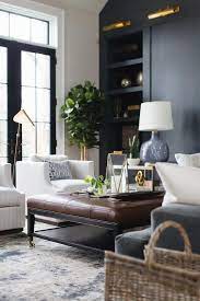 Reclaimed pine driftwood look coffee table. A Brown Leather Tufted Ottoman Sits On A Silver And Blue Rug Between A Gray Velvet Sofa And Side By Side Living Room Leather Living Room Grey Brown Living Room