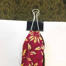 Fold the extra inch you braided into the center braid so that the four strands lie side by side, to the right of the braid. 2