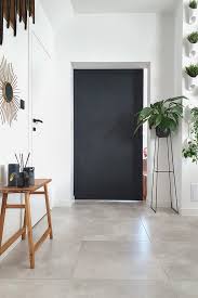 The black door balances the void so the blank screen isn't the only dark expanse in the room. Black Wooden Sliding Door In The Living Room Reno Doors