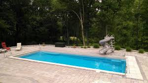 This Backyard Patio Made Our Goliath Fiberglass Pool Design Take Center Stage By Contrasting The Light Tan Thursday Pools Fiberglass Swimming Pool