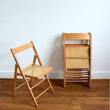 Constructed from solid wood with a curved back and slatted seat, this wooden chair is high on durability and style. Vintage Folding Chair In Wood And Cane 1960s Design Market