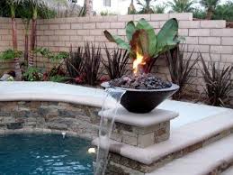 It features a column that pours the water out the sides into a lower basin that is raised off the ground around the column. Pantheon Fire And Water Fountain Feature Backyard Water Feature Landscaping Water Feature Front Garden Design