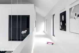 Mix and match beaded throw pillows, wool or fur blankets, and velvet decor to soften up the harsh starkness of a minimalist room—just be sure the items match the neutral color scheme you've set! Minimalist House Interior In Black And White Decor Interiorzine