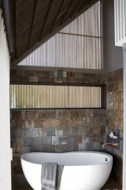 The bathroom tile ideas in the picture creates a clear separation between the floor and wall. Creative Bathroom Tile Design Ideas Tiles For Floor Showers And Walls In Bathrooms