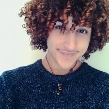 A Photograph Of A Young Black Male With Dyed Coiled Curls In A Long Hairstyle Resembling The Hair Style O Curly Hair Men Long Hair Styles Men Curly Hair Styles