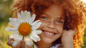 A girl with a daisy flower