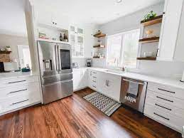 A mint green, wine glass tile backsplash earns a pop of color; White Kitchen Remodel From Dark Cherry To Bright White