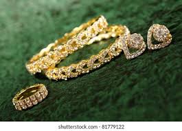 Gold plated jewelry necklace with earring, ring & bengal. Gold Ring Bengals On Green Textured Stock Photo Edit Now 81779122