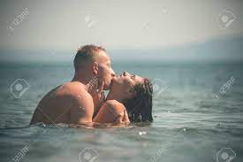 The hug highlights a good physical connection and mutual trust between the two people. Couple Full Of Desire Hugs In Sea Couple In Love Hugs And Kissing In Ocean Water Brunette With Handsome Passionate Lover Girl With Macho Makes Love Love And Romantic Concept Stock Photo