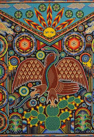 An eagle is shown devouring a bird while perched on a flowering cactus. Mexican Eagle Huichol Mexican Art Mexican Folk Art Visionary Art