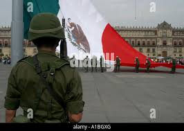 A Mexican soldier stands guard in front of a charred auto in front of the  Piedras Negras City Hall and jail, Dec. 31, 1984, after supporters of a  defeated mayoral candidate set