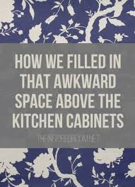Remove the door from the corner cabinet, then install hooks to hang pots and pan: Filling In That Space Above The Kitchen Cabinets