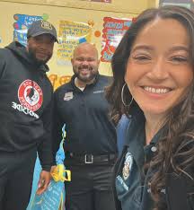 3rd Precinct Community Service Officer S. Pereira and School Resource  Officer R. Charles alongside Senior Aide from the Mayor's office, Annie  Ferreira, had the honor to participate in the Reading Across America