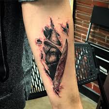 The Start To My Horror Sleeve Michael Myers Skin Tear Done At The Perfect Time Of Year Ripped Skin Tattoo Skin Tear Tattoo Creepy Tattoos