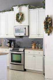 But what is the best way to deal with the gap between cabinet and ceiling—or just the gap for purposes of this article—so that it looks like an intentional part of your. White And Green Christmas Decor Above Kitchen Cabinets Decorating Above Kitchen Cabinets Fall Kitchen Decor