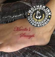 Red Cursive Lettering Tattoo By Mother Ink Red Tattoos Tattoo Lettering Red Tattoo Words