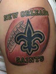 The tattoo features the super bowl lv logo and the lombardi trophy. New Orleans Saints Tattoo Saint Tattoo New Orleans Saints New Orleans