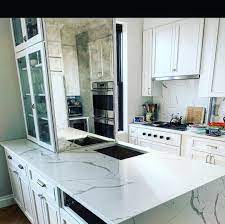 White Kitchen Cabinetry With Quartz Countertops With Waterfall Edge And Quartz Backsplash Kitchen Design Kitchen And Bath Design Kitchen Remodel