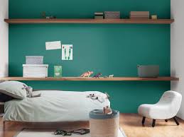 Turquoise wallpaper with a forest of gold trees. Using Dark Teal Paint In Your Home Dulux