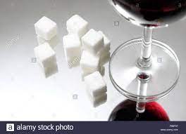 White Granulated Sugar Cubes And Glass Of Red Wine Stock Photo Alamy
