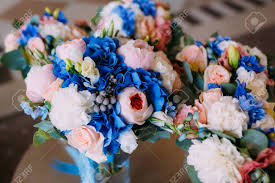 Since it can be extremely hard to find fresh flowers in a good shade of blue, it only makes sense to choose premium quality artificial flowers! Three Bridal Bouquets With Creamy Roses And Peonies And Blue Stock Photo Picture And Royalty Free Image Image 96554208
