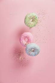 sweet and colourful doughnuts with sprinkles falling or flying i pastel pink aesthetic pink background aesthetic iphone wallpaper