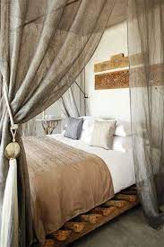 Here the design team added patterned, blue curtains to a black canopy bed. Pin By Sabrina Brett On Sweet Dreams Rustic Bedroom Bedroom Design Rustic Bedroom Design