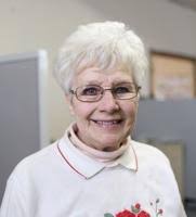 Jerry Lindstrom's phone collection connects to the past. Jerry is pointing  out to Pete Peterson, Grasston, the oldest phone in his collection- a  Stromberg -Carlson from 1898.