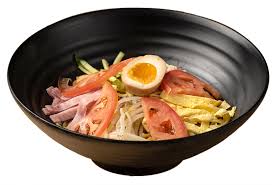 Yakiniku donburi is a japanese rice bowl dish of sauteed beef and vegetables served over a bed of rice and garnished with sesame seeds. Moto Ramen