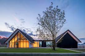 Modern house with greenhouse attached. Maas Architecten Merges A Thatched Cottage With A Glass Greenhouse