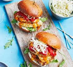 Place a lettuce leaf and a slice of tomato on top, then add a burger, a. 15 Minute Chicken Halloumi Burgers Recipe Bbc Good Food Recipes Chicken Burgers Recipe Chicken And Halloumi