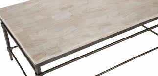 Our wide round coffee table provides an ideal spot to place your books, magazines, or fresh flowers upon with an urban industrial look. Vida Stone Top Coffee Table Coffee Tables Ethan Allen