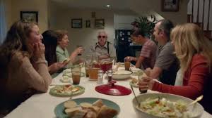 A Large Family Is Gathered Around The Dinner Table Listening To A Story From The Grandfather S Past As Everyone Eats O Cat Call Tv Commercials Family History