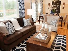 Adding a mirror above the sofa is a great way to create the sense of space. Bold Graphic Black And White Patterned Curtains Pillows And A Rug Fill This W 2019 Bol Brown Living Room Decor Brown Couch Living Room Brown Sofa Living Room