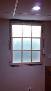 windowless dining room a backlit french door was created and given panel drapes fake windows basement window installation fake window