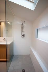 A mid century modern apartment ops for classic cottage style in the master bathroom, with a tub and fittings by lefroy brooks, a stool from room & board, and floors and walls sheathed in white dolomite marble. Kitchen Bath Remodel Gives Mid Century Home Modern Updates