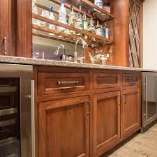 A beverage fridge, and a sink and faucet. Remodeled Basement With Wet Bar Degnan Design Build Remodel