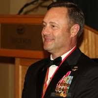 Col. Brian Murtha, Commanding Officer (left) speaks