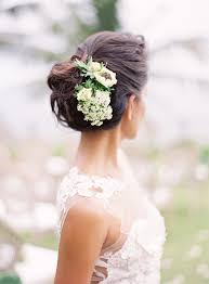 Wedding hairstyle with tiny flowers and a veil. 20 Wedding Hairstyles With Flowers Martha Stewart