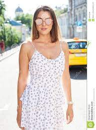 A Hot Summer in the City. Portrait of a Girl in a Light White Dress and  Sunglasses Posing on a Hot Afternoon on the Stock Photo - Image of chic,  happy: 98532208