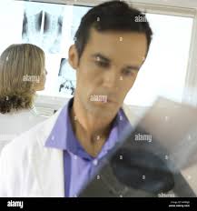 A doctor or radiologist holds an X-ray of a person's foot. Leg injury,  crack or fracture of heel Stock Photo