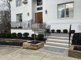 The black wrought iron railing gives this sturdy brick home a more delicate, open atmosphere. Exterior Ironwork Finelli Ironworks