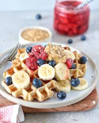 chloe munro on instagram crispy waffles topped with sliced bananas blueberries strawberry compote peanut waffle toppings strawberry compote crispy waffle