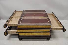 Mahogany finished center table with marquetry veneer top, bolshoi gold finish on molding, golden brass accents. Maitland Smith Stacked Book Leather Bound Large 3 Drawer Cocktail Coffee Table For Sale At 1stdibs