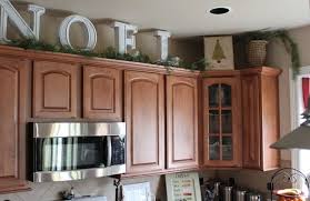 Big Letters And Pine Garland Above The Kitchen Cabinets Christmas Kitchen Christmas Home Above Kitchen Cabinets