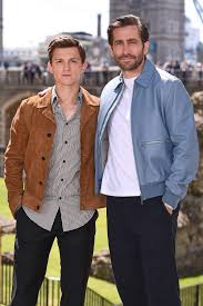 White Crew Neck T Shirt With Blue Bomber Jacket And Navy Dress Pants Alongside Tom Holland Wearing White S Tom Holland Jake Gyllenhaal Tom Holland Peter Parker