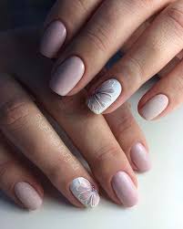 My friend polishes pale blue and white coats on nails first. 25 Delicate Flower Nail Designs Adding Lovely Blooms To Your Fingertips